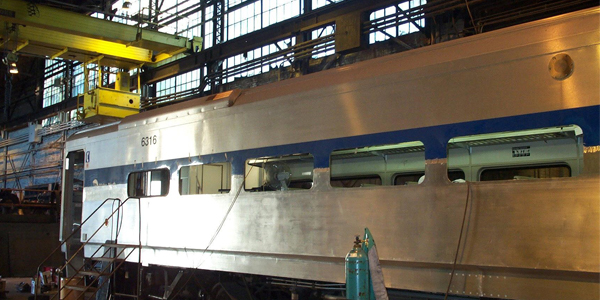 exterior of rail car undergoing refurbishment in Delaware Car company facility