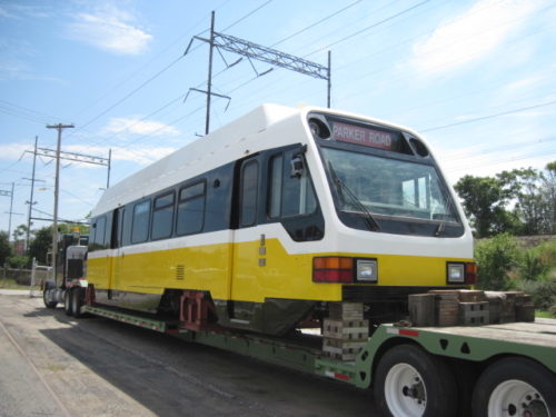Rail car transported on trailer